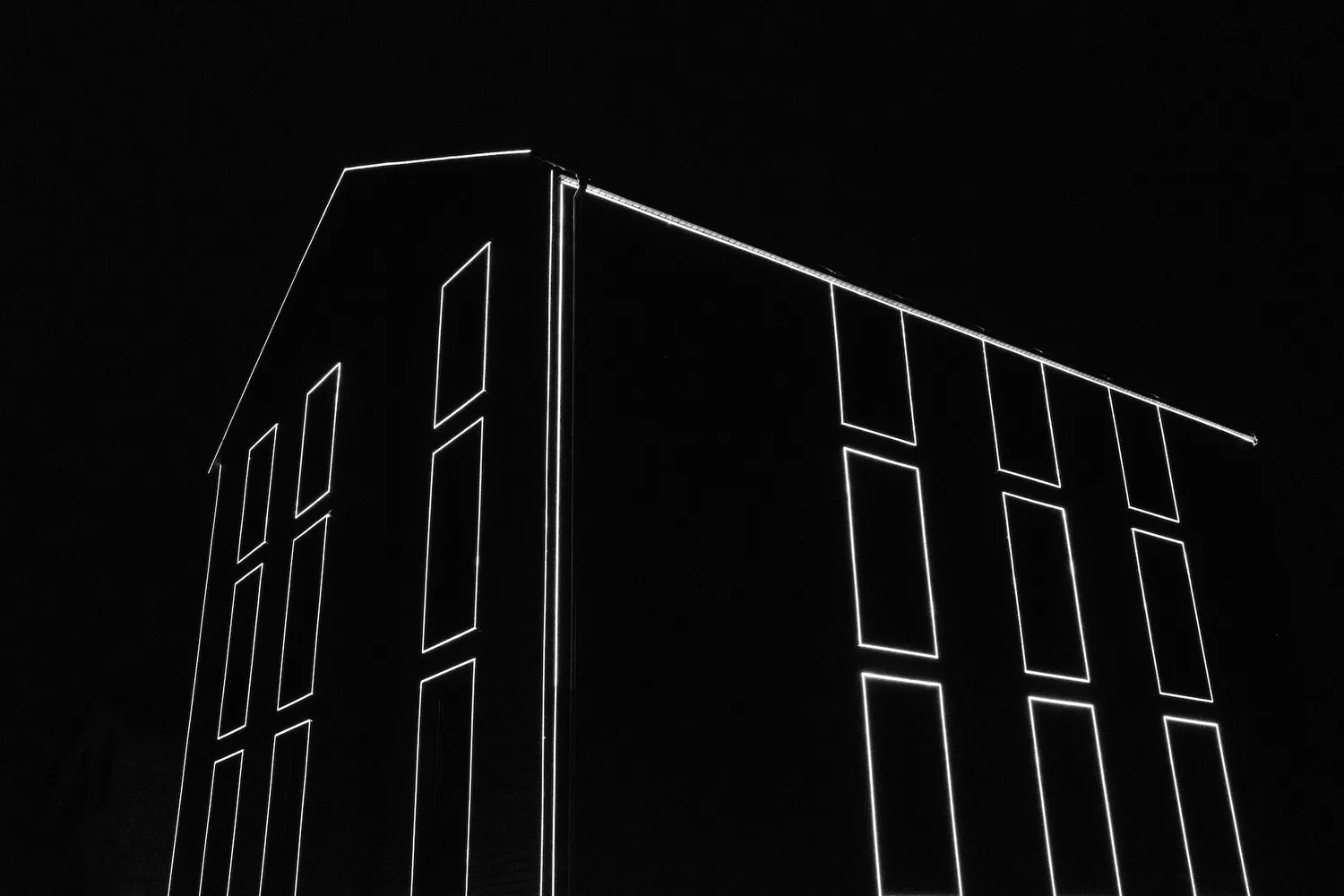 An unfinished house decorated with neon lights, at night – Yerevan