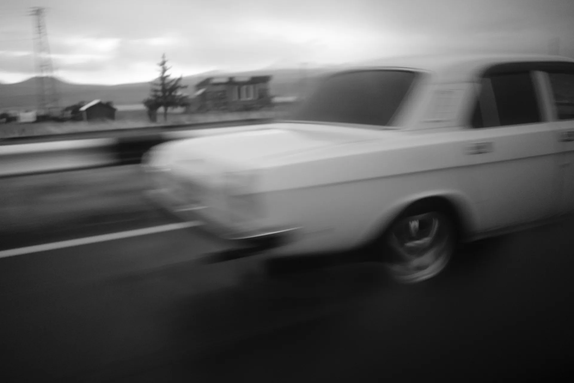 A car speeds on the road near Sevan