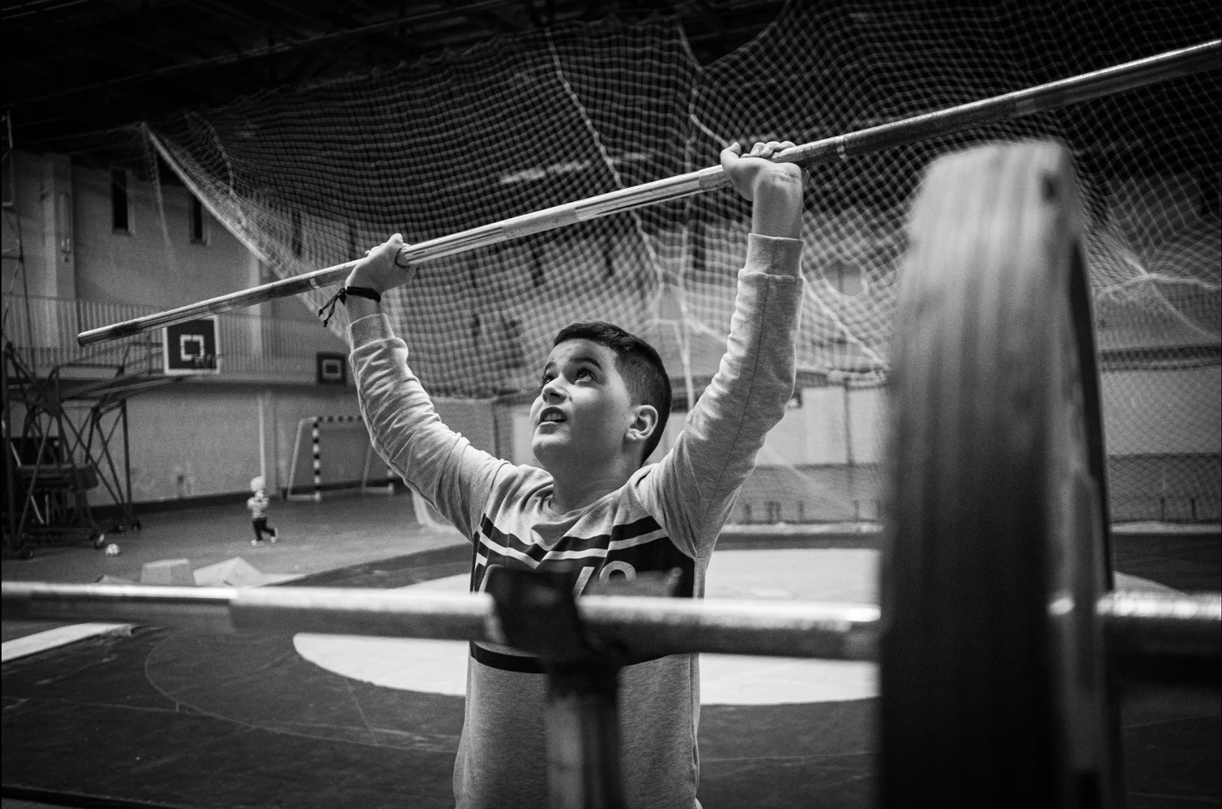 An Artsakh displaced person plays in a makeshift gym