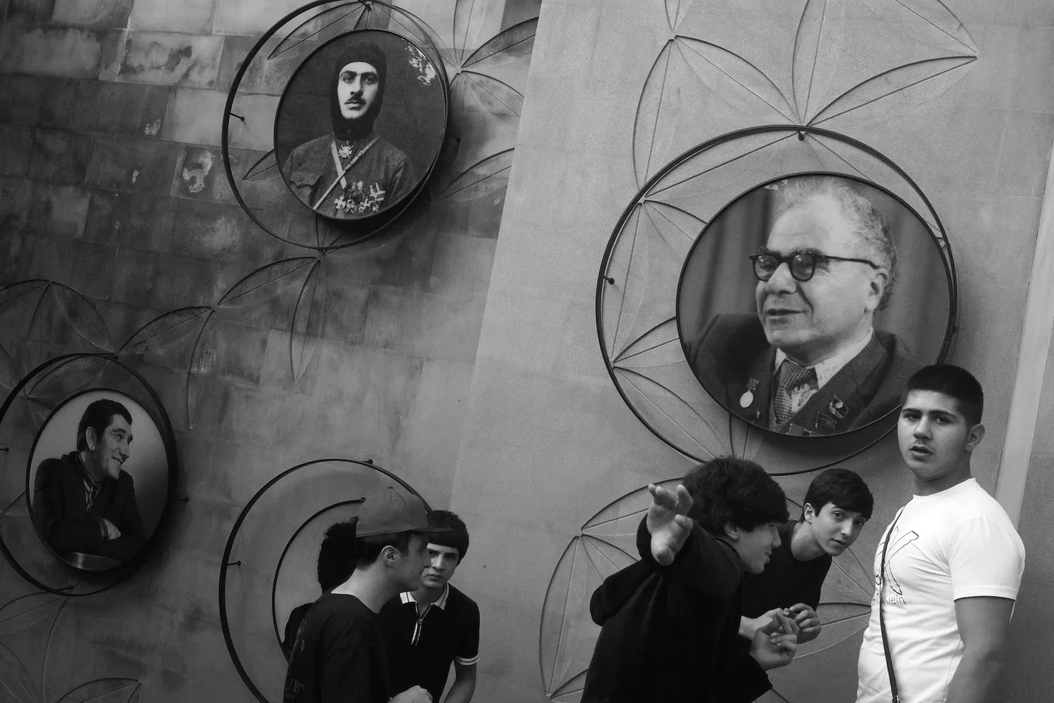 Guys having fun in Yerevan, beneath the portraits of Armenian heroes, intellectuals, and artists