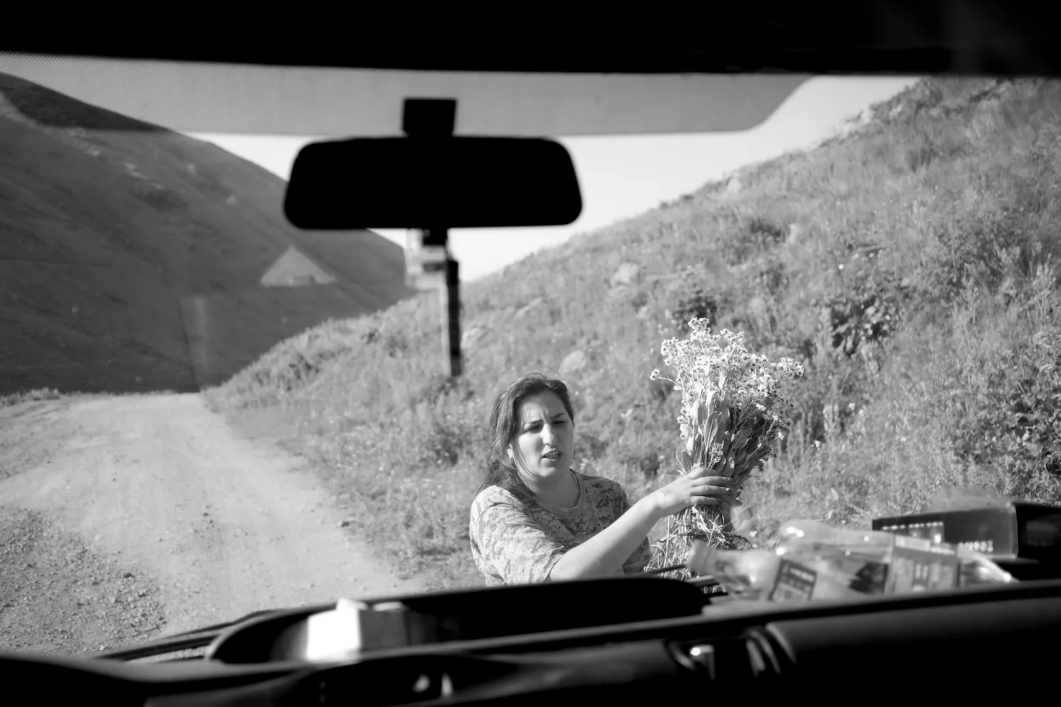 A woman carrying flowers she has just picked