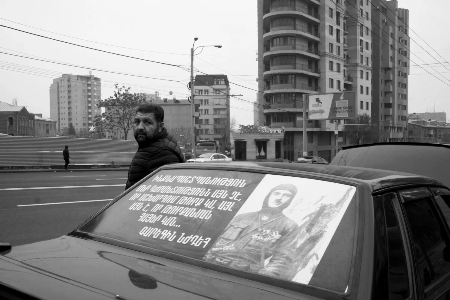 A man steps out of his car decorated with the memory of a famous Armenian hero, Garegin Nzhdeh